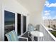 Relaxing balcony with outdoor furniture, providing picturesque views of the coastline at 13500 Gulf Blvd # 505, Madeira Beach, FL 33708