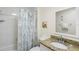 Bright bathroom featuring a shower-tub, granite countertop vanity, and decorative mirror at 13500 Gulf Blvd # 505, Madeira Beach, FL 33708