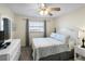 Comfortable bedroom featuring a queen bed, dresser, and window with blinds at 13500 Gulf Blvd # 505, Madeira Beach, FL 33708