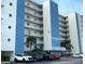 Sea Breeze condo building exterior view with parking, showcases coastal living at its finest at 13500 Gulf Blvd # 505, Madeira Beach, FL 33708