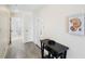 Well-lit condo hallway with gray floors and ocean-themed decor leading to bathroom at 13500 Gulf Blvd # 505, Madeira Beach, FL 33708
