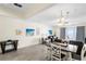 Open-concept floor plan with dining table and seating area with a view of the beach at 13500 Gulf Blvd # 505, Madeira Beach, FL 33708