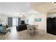 Open-concept living and dining area featuring modern furnishings, tile floors and access to the balcony with ocean views at 13500 Gulf Blvd # 505, Madeira Beach, FL 33708