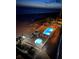 Nighttime view of the pool and hot tub, located directly on the beach at Sea Breeze at 13500 Gulf Blvd # 505, Madeira Beach, FL 33708