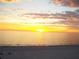 Gorgeous sunset view of the ocean, with sky ablaze in warm hues, promising tranquility at 13500 Gulf Blvd # 505, Madeira Beach, FL 33708