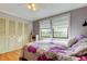 Serene bedroom with natural light, built-in closet, and laminate floors at 136 Sycamore Ln # C, Oldsmar, FL 34677