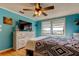 Inviting bedroom featuring a dresser with TV, a large window, and laminate floors at 136 Sycamore Ln # C, Oldsmar, FL 34677