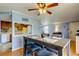Cozy dining area with seating for four adjacent to kitchen and living area, featuring hardwood floors and ceiling fan at 136 Sycamore Ln # C, Oldsmar, FL 34677