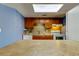 Functional kitchen featuring wood cabinets, tiled backsplash, and white appliances at 136 Sycamore Ln # C, Oldsmar, FL 34677