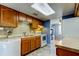 Functional kitchen features wood cabinets, tiled backsplash, and white appliances at 136 Sycamore Ln # C, Oldsmar, FL 34677