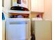 Functional laundry room with washer, dryer, and overhead storage for convenience at 136 Sycamore Ln # C, Oldsmar, FL 34677