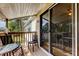 Inviting covered patio with seating and sliding glass doors leading indoors for easy access at 136 Sycamore Ln # C, Oldsmar, FL 34677