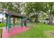 Charming picnic area featuring covered tables, green grass, and a playground, perfect for outdoor dining and Gathering gatherings at 136 Sycamore Ln # C, Oldsmar, FL 34677