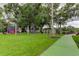 A spacious playground area with slides, swings, picnic tables, and lush green grass, perfect for outdoor fun and community gatherings at 136 Sycamore Ln # C, Oldsmar, FL 34677