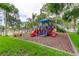 A colorful community playground with slides and climbing structures, set amidst lush greenery and perfect for recreation at 136 Sycamore Ln # C, Oldsmar, FL 34677
