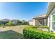 A well-maintained backyard shows a property's lush green lawn, a dark metal fence, and tidy landscaping at 13915 Kingfisher Glen Dr, Lithia, FL 33547