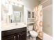 Bathroom featuring a single sink vanity, overhead shelving, and a shower/tub combo with sunflower curtain at 13915 Kingfisher Glen Dr, Lithia, FL 33547