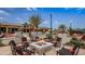 Community amenity includes a fire pit surrounded by seating with pool and clubhouse views at 13915 Kingfisher Glen Dr, Lithia, FL 33547