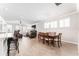 Bright dining room features a modern chandelier, natural light, and access to the kitchen and living areas at 13915 Kingfisher Glen Dr, Lithia, FL 33547