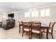 The dining room is well lit with an open layout to the living room and a contemporary light fixture at 13915 Kingfisher Glen Dr, Lithia, FL 33547