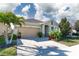 Charming one-story home featuring a two-car garage, a brick paved driveway, and beautifully landscaped yard at 13915 Kingfisher Glen Dr, Lithia, FL 33547