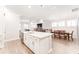 Kitchen island with white cabinets and an open concept view of the living room and dining room at 13915 Kingfisher Glen Dr, Lithia, FL 33547