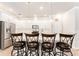Kitchen island with seating, stainless steel appliances, and a sink at 13915 Kingfisher Glen Dr, Lithia, FL 33547