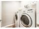 Laundry room featuring a full-size washer and dryer, ensuring convenient laundry days at 13915 Kingfisher Glen Dr, Lithia, FL 33547