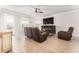 Open living room with modern flooring, a large TV, and ample seating for entertaining at 13915 Kingfisher Glen Dr, Lithia, FL 33547
