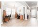 Bright open concept office space with wood look tile floors, white trim, and access to hallway and front door at 13915 Kingfisher Glen Dr, Lithia, FL 33547