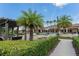 Resort-style pool area with lush landscaping, palm trees, and comfortable lounge seating at 13915 Kingfisher Glen Dr, Lithia, FL 33547
