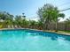 Inviting pool area with tropical landscaping providing a private outdoor oasis for relaxation and enjoyment at 13924 Oak Forest S Blvd, Seminole, FL 33776