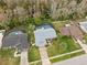 An aerial view of a single-Gathering home featuring a screened-in pool, well-maintained lawn, and mature landscaping at 15306 Winterwind Dr, Tampa, FL 33624