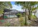 Backyard featuring the pool, the lanai, mature landscaping and partially fenced at 15306 Winterwind Dr, Tampa, FL 33624