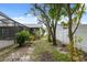 Secluded backyard with tropical plants, pavers, and a screened-in pool area at 15306 Winterwind Dr, Tampa, FL 33624