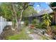 Private backyard with garden area, stepping stones, and view of the enclosed pool area at 15306 Winterwind Dr, Tampa, FL 33624