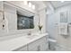 Bright bathroom with quartz countertop vanity, modern fixtures, and a large mirror at 15306 Winterwind Dr, Tampa, FL 33624