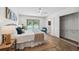 Inviting bedroom with wood floors, ensuite bathroom, and pool views through a sliding glass door at 15306 Winterwind Dr, Tampa, FL 33624