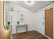 Entryway with wood floors, table, stylish mirror and white front door at 15306 Winterwind Dr, Tampa, FL 33624