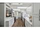 Bright kitchen with modern appliances, white cabinets, and a view of the entryway at 15306 Winterwind Dr, Tampa, FL 33624