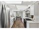 Bright kitchen featuring stainless steel appliances, quartz counters and wood floors at 15306 Winterwind Dr, Tampa, FL 33624
