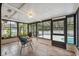 Comfortable sun room with tile floor and large windows overlooking the pool at 15306 Winterwind Dr, Tampa, FL 33624
