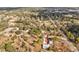 Drone shot of home showing long driveway, garage, and surrounding tree coverage at 15630 Camrose Ave, Spring Hill, FL 34610