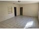 Bright living room with white walls, tile floors, and built-in shelving at 1609 W Knollwood St, Tampa, FL 33604