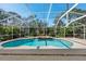 Inviting screened-in pool area surrounded by lush greenery and a relaxing water feature at 18908 Fairwood Ct, Tampa, FL 33647