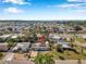 Aerial view of the house and surrounding neighborhood with nearby waterway in the distance at 2007 Yale Ave, Bradenton, FL 34207