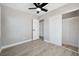 Bedroom with wood-look floors, ceiling fan, and open closet at 2007 Yale Ave, Bradenton, FL 34207