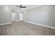 Bright living room boasts fresh paint, durable floors, modern fan, and a view into the adjacent hall and bathroom at 2007 Yale Ave, Bradenton, FL 34207