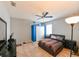 Bedroom featuring tiled floors, ceiling fan and blue accent wall at 20330 Natures Corner Dr, Tampa, FL 33647