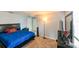 Comfortable bedroom with a soft carpet, dresser with a mirror, and cozy bed with a blue comforter at 20330 Natures Corner Dr, Tampa, FL 33647